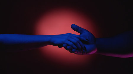 Diverse relationship. Romantic couple. Man boyfriend in love holding woman girlfriend hand in red pink spotlight on dark advertisement background.の写真素材