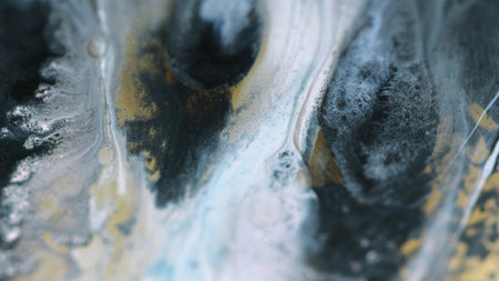 Paint spill. Liquid art. Defocused blue golden black color sparkling particle texture fluid ink mix...