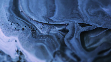Fluid glitter drip. Bubble paint spill. Defocused blue black white color wet shimmer oil emulsion flow abstract art background.の写真素材