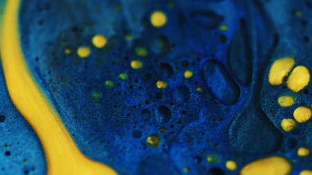 Oil paint blend. Glitter fluid. Blur blue yellow color shimmering particles texture ink emulsion bubble drop spill mix abstract background.の写真素材