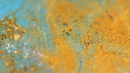 Shiny oil bubbles. Sparkling ink. Blur blue golden color metallic sequin particles gloss fluid paint...