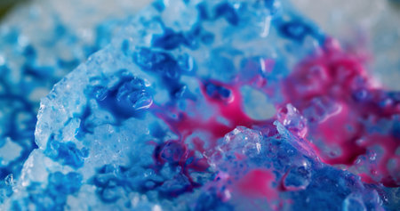 Ink water drop. Abstract paint. Blue pink color ice liquid blending flow mixing fluid splash spilling on blurred art texture bokeh light background.の写真素材