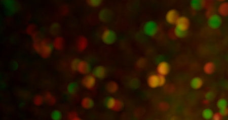 Blurred bokeh. Luxury glitter. Multicolor yellow green red purple round gleaming blinking lens flare...