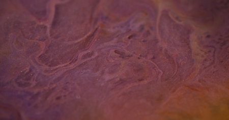 Marble fluid. Blurred paint spill. Defocused purple orange color shimmering texture emulsion blend ink stream wave abstract art background.の写真素材