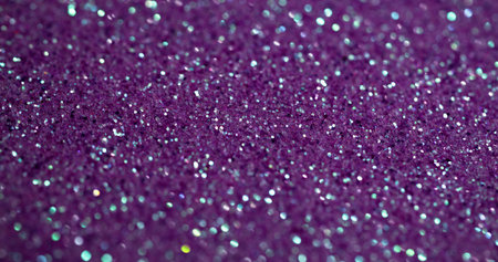 Violet sparkling. Purple glitter. Flare shimmering festive surface with metallic dust. Shining precious blur lilac glamour particles.の写真素材