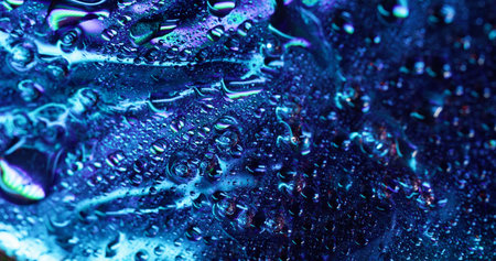 Shiny drops. Moisture metal. Blue illuminated area covered with watered foil effect. Smooth...