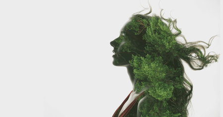 Creative portrait. Nature harmony. Double exposure profile silhouette of peaceful woman with green forest foliage motion in flying hair isolated on white copy space background.の写真素材