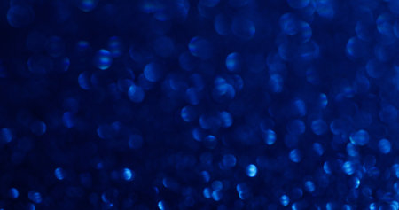 Defocused shimmer. Glittery flare. Decorative festive background with blue chaotic circles flickering rays delicate fantasy atmosphere.の写真素材