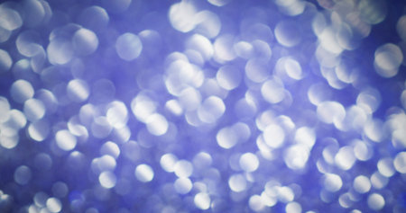 Bokeh glitter. Violet gloss. Variable lilac dispersion with illuminated light spots. Festive blur background with airy mystical sequins.の写真素材