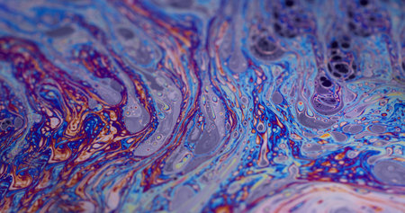 Psychedelic abstract background. Iridescent surface. Defocused multicolor purple green liquid oil...