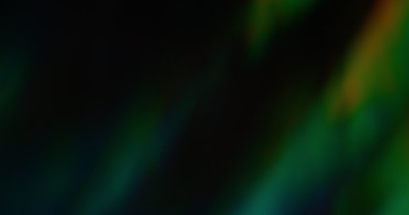 Blur color flare. Glowing light effect. Defocused leak green yellow rays flickers holographic gradient beam lens flare on abstract dark black art.の写真素材