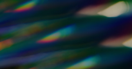 Colorful light effect. Abstract party background. Defocused leak green yellow rays rainbow flickers gradient beam lens flare on blurred art dark overlay.の写真素材