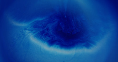 Blur glitter oil. Sparkling paint flow. Blue white multicolor fluid shimmering liquid gleaming ink water moving on abstract bokeh light background.の写真素材