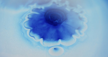Oil fluid flow. Blur glitter texture. Blue white color sparkling shimmering particles paint drop ink wave falling on abstract art background.の写真素材