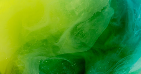 Paint swirl. Green cloud. Smoky liquid with layered bright dye small particles. Defocused color wavy watercolor art background.の写真素材