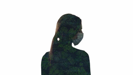 Air pollution. Nature protection. Aerial view of forest trees with smog dust double exposure silhouette of woman in face mask isolated on white empty space background.の写真素材
