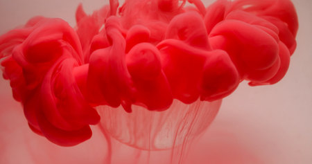 Paint cloud. Flow ink. Defocused red color smoke texture fluid splash over glass bubble on abstract art light background.の写真素材