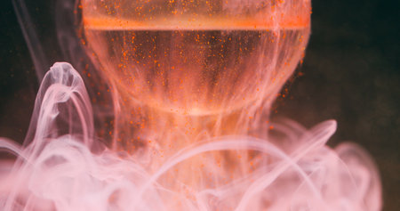 Smoke splash paint. Ball background. Defocused orange pink colorful water round texture fluid wave...