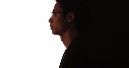 Smart silhouette. Leader face. Dark contrast profile outline of confident pensive business man in...