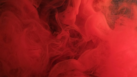 Wavy smoke. Red fog. Mixing bright ink with liquid. Whimsical flow paint with translucent smooth...