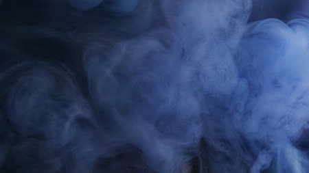 Smoke particles. Fog fluid. Mysterious blue thick mist ink swirls on defocused dark abstract...
