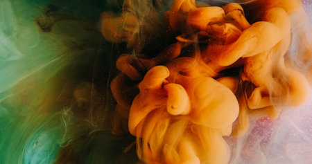 Smoke cloud. Paint drop water. Orange green color vapor splash floating on pink glitter particles...