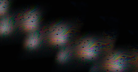 Rainbow swirl. Stroboscopic light. Iridescent liquid ink art blend on black background. Neon...