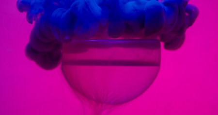 Smoke splash paint. Ball background. Defocused neon blue colorful fume bead round texture floating on abstract pink purple creative art.の写真素材