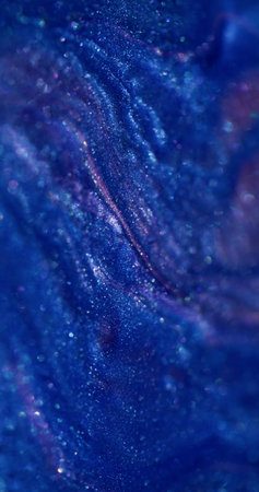 Spilling ink. Shiny stains. Blur blue purple colorful marble enamel texture paint fluid in water spreading on abstract bokeh background.の写真素材