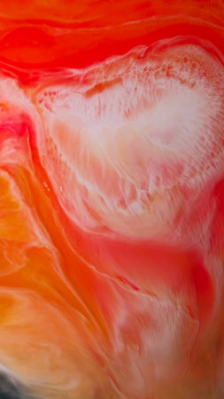 Flow stain. Marble texture. Defocused orange red colorful ink in water liquid acrylic mix spreading on abstract art background.の写真素材