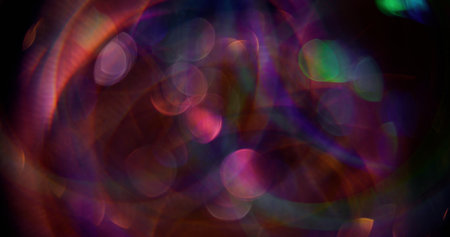 Defocused round glow. Mix light flares. Sparkling purple color particles lens flash motion on blurred background with bokeh effect.の写真素材