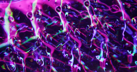 Neon glow. Defocused colorful splash. Purple gleaming transparent fragments lens flare motion on blurred bokeh light modern background.の写真素材
