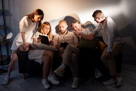 Discussion photo. Team photographers models review shoot results. Friendly communication colleagues project ideas.の写真素材