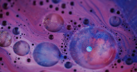 Gleaming fluid. Defocused soap texture. Blinking beautiful blue pink paint liquid colorful bubbles...