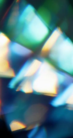 Bokeh energy. Blur ray abstract. Defocused green blue yellow multicolor flare light magic lens texture on dark black background.の写真素材