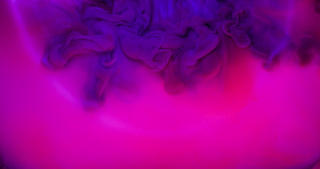 Smoke explosion. Round lens. Purple ink haze flow neon fantasy spreading on bright pink fluid surface. Circle beam light abstract background.の写真素材