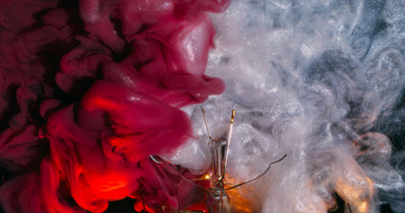 Sparkling fume. Paint mix. Silver white red shimmering ink smoke drops swirling dark water. Abstract...