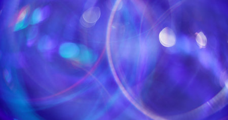 Swirling circle. Blurred shiny glow. Multicolored blue pink circles lens flare on bokeh light...