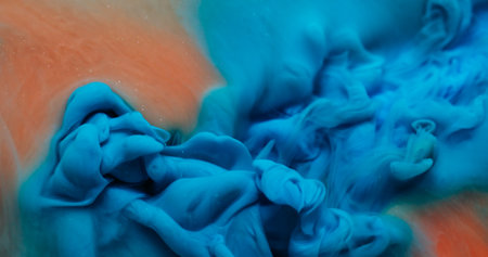 Fume particles. Paint mix. Defocused orange blue color water texture chemical vapor acrylic liquid floating on abstract art background.の写真素材