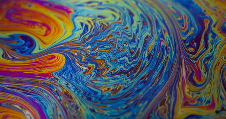 Oil liquid. Paint stains. Defocused orange green blue color wet bubbles texture floating on abstract creative purple pink background.の写真素材