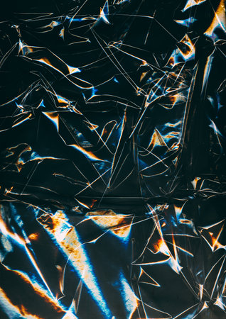 Distressed foil. Old film overlay. Blue orange color glow dust scratches wrinkled worn uneven texture dark black art abstract background.の写真素材