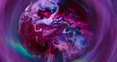 Flow texture. Round emulsion. Defocused red purple yellow colorful ink silver circle spreading on abstract neon acrylic background.の写真素材