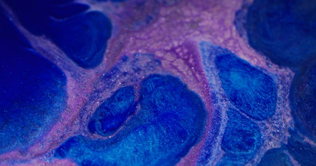 Lilac splatter. Shimmer texture. Defocused purple blue color ink sparkling liquid glitter stream floating on abstract art background.の写真素材
