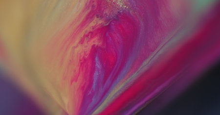 Flowing liquid. Shimmer ink. Defocused pink purple yellow colorful splash water particles sparkling texture on abstract background.の写真素材