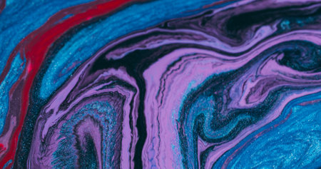 Splatter art. Paint fluid. Defocused blue purple red color chemical splash particles flowing on abstract acrylic creative background.の写真素材