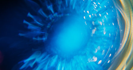 Shiny ray. Bokeh circle. Defocused blue yellow colorful radiant golden fluorescent lens flare moving on abstract neon blurred background.の写真素材