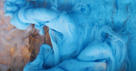 Underwater fume. Ink background. Blur blue color smog twirling pigment particles spreading on acrylic wooden bark art abstraction.の写真素材