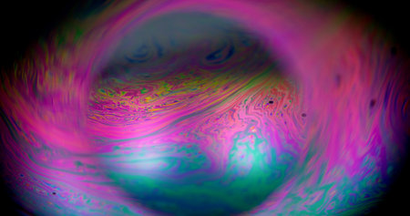 Paint defocused swirl. Liquid planet sphere. Glowing globe colorful light halo. Abstract oil flow fluorescent purple pink blue round lens background.の写真素材