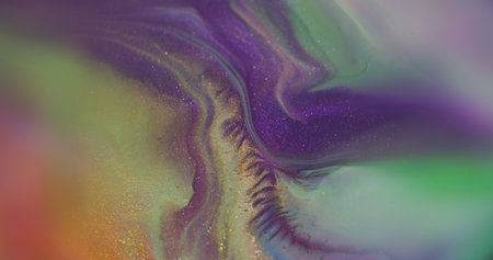 Color mix. Shiny texture. Defocused purple green yellow paint splash shimmering particles spreading on abstract bokeh creative background.の写真素材