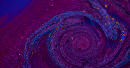 Swirling paint. Ripple particles. Defocused blue purple red color flowing golden yellow water...